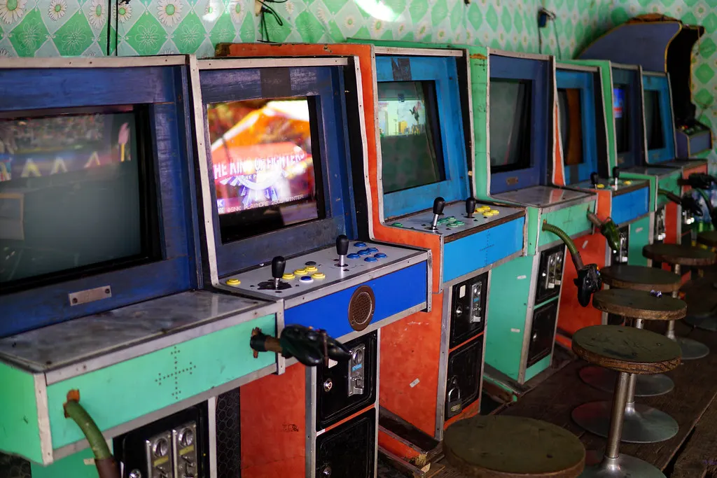 Colourful arcade machines glowing in a gaming space